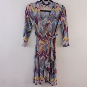 BCBGMaxAzria dress in vibrant geometric print with V-neckline and cinched waist